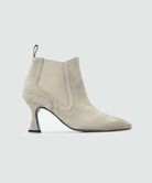 A beige suede ankle boot with a pointed toe and a curved heel, displayed against a white background.
